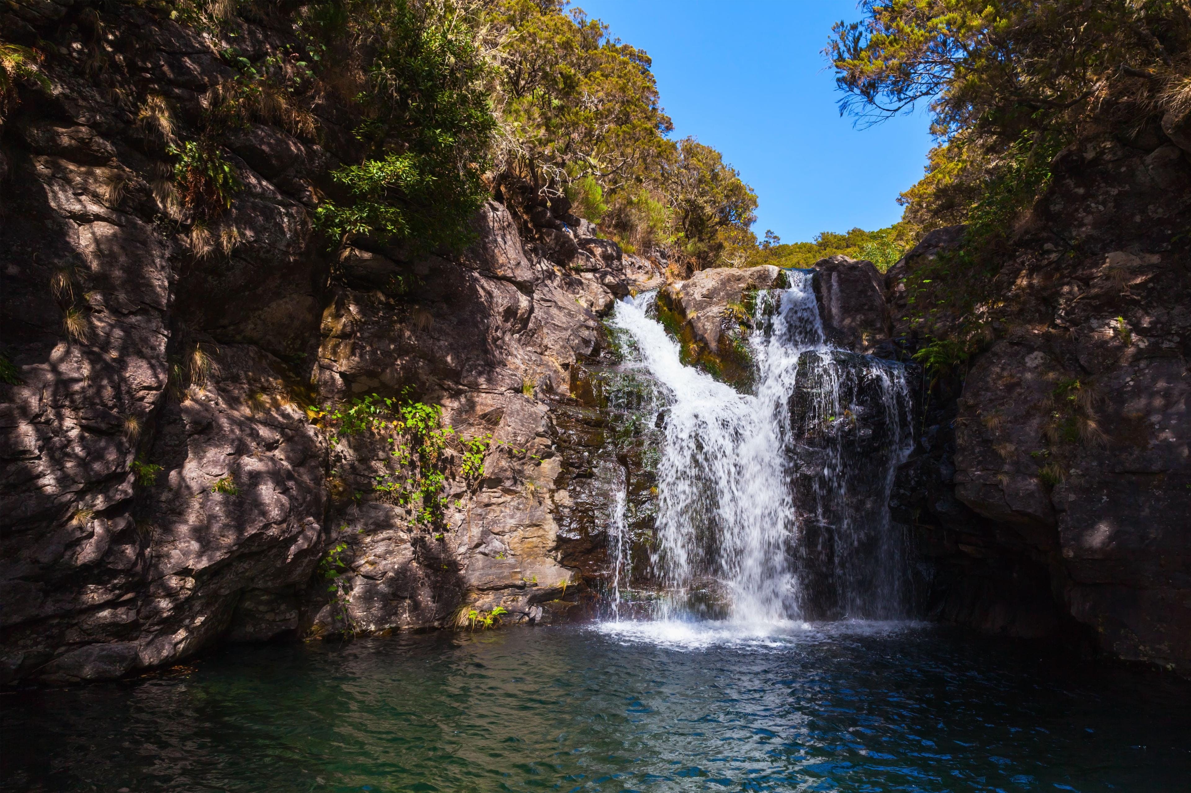 A beautiful photo of a waterfall in Portugal that you can see when you do rafting and canyoning in Madeira.