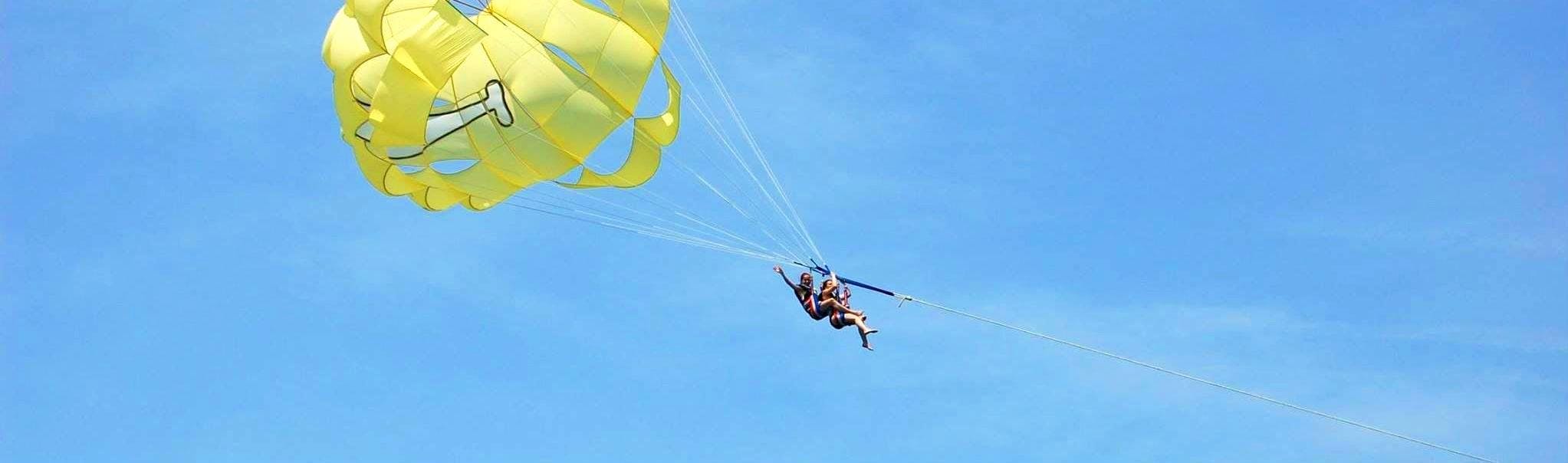 Friends are taking off from the beach while starting Parasailing in Villeneuve-Loubet with Plage des Marines.